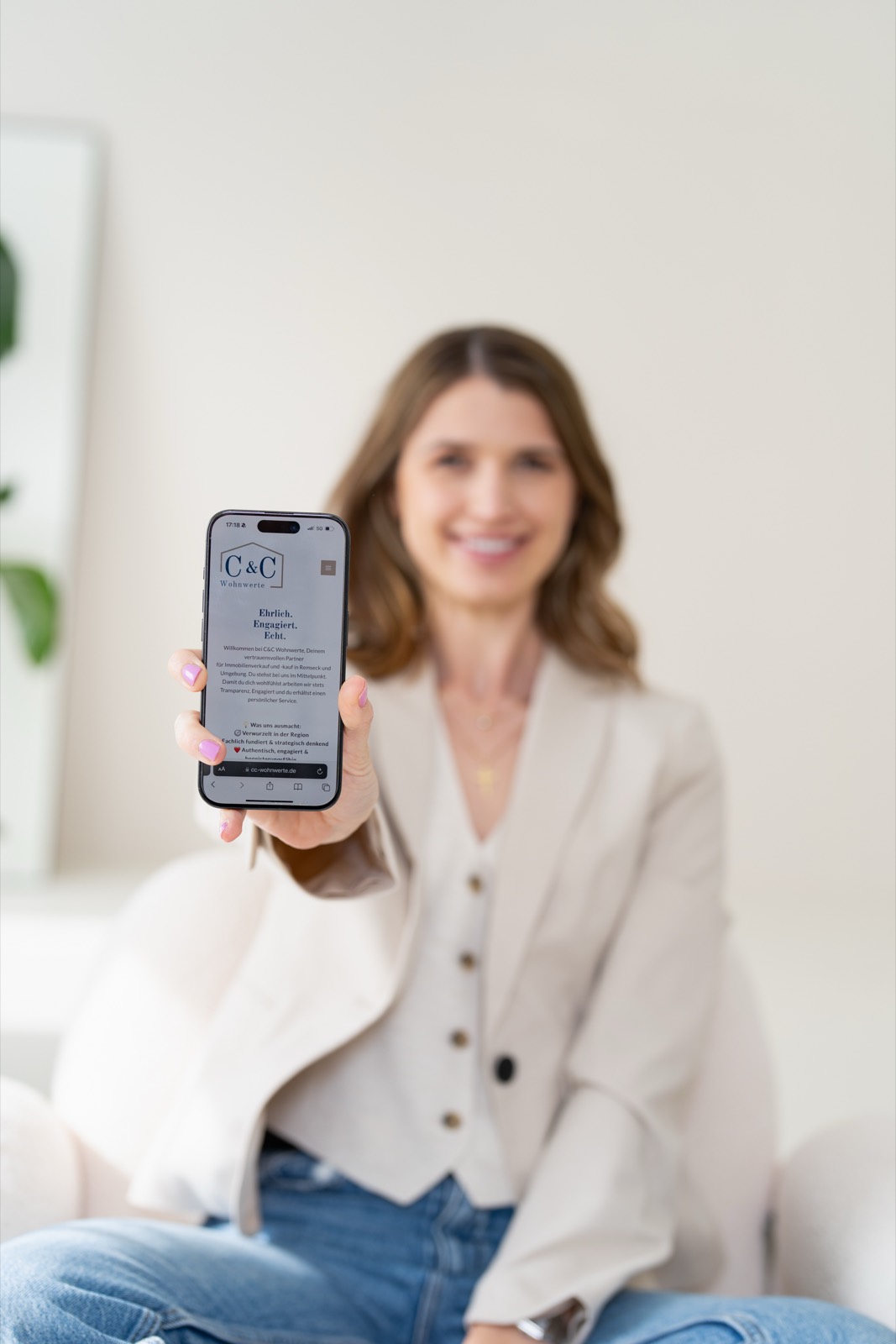 Carina zeigt eine Objekt-Website auf dem Smartphone